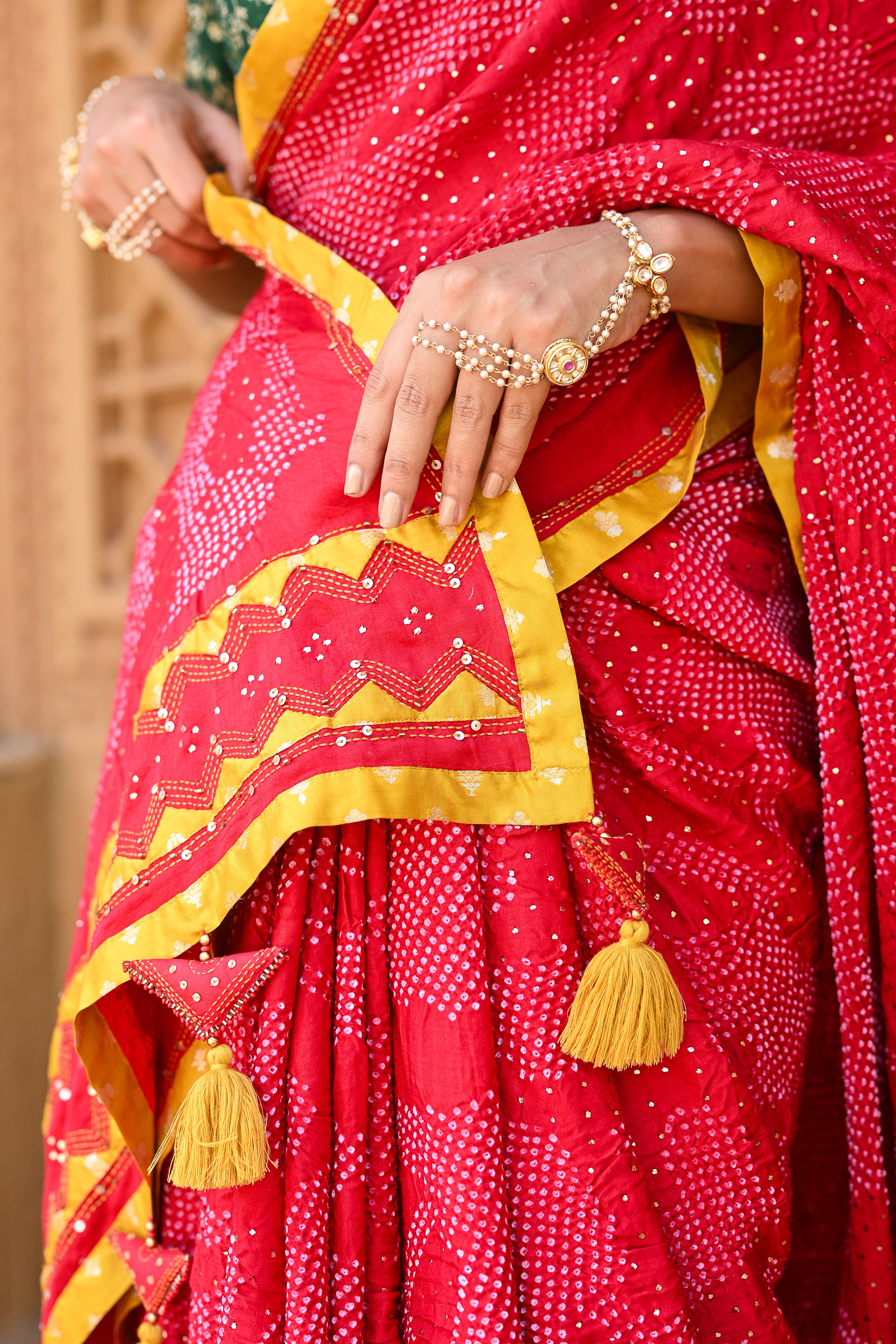RED APPLIQUE EMBROIDERED SILK BANDHANI SAREE WITH TASSELS