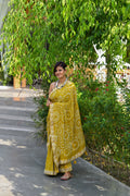MUSTARD YELLOW CIRCLES OF THE LIFE BANDHANI SILK SAREE WITH MIRROR WORK AND LACE BORDER
